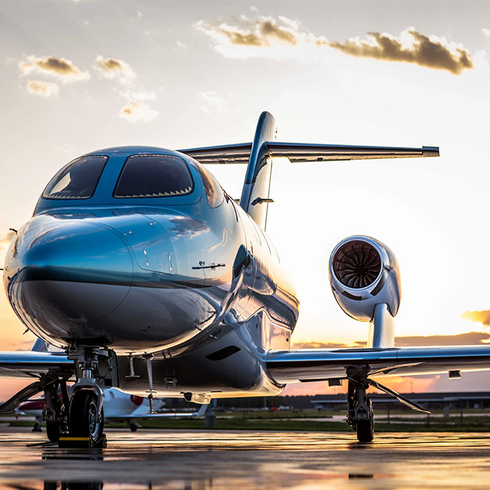 Aeronave pousada na pista com o por do sol no fundo